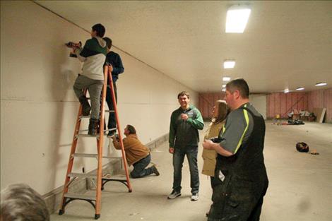 Courtesy photo Baseball players with the Mission Valley Mariners use sweat equity to install drywall in the horticulture barn.