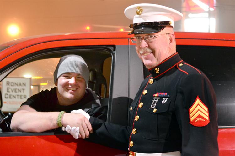 Marine Sgt. Chuck Lewis greets Tomy Parker.