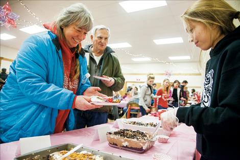 Emily Fiddler dishes up a chocolate treat for Patti Sowkagets.