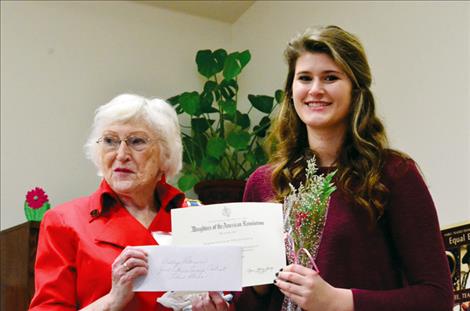 Daughters of the American Revolution Regent Bonnie Huber awards Ashley Peterson first place in the essay contest. 