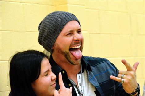 Jared Blake poses for photos and signs autographs after sharing his life story to help inspire St. Ignatius students.    