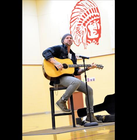 Country music artist Jared Blake sings a few of his songs for students.