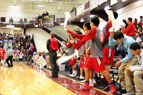 The Arlee Warrior’s bench erupts in the semi-final game of the District 14C tournament in Pablo.