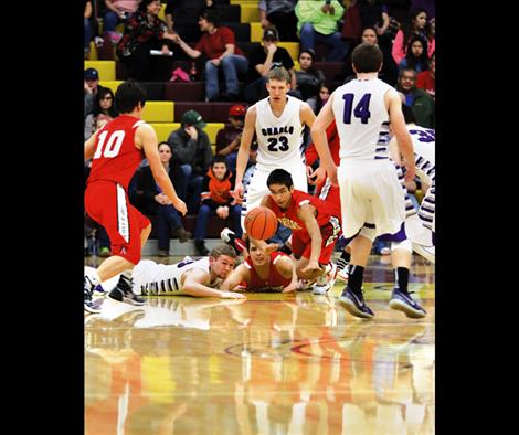 Charlo Vikings and Arlee Warriors dive for a loose ball.