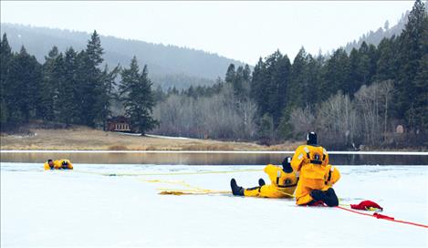 Lake County Search and Rescue and Polson Rural Fire departments train for ice rescues Saturday on Jette Lake.