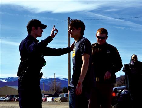St. Ignatius Police Officer Patrick Nobles gives Kaleb Durglo a field sobriety test  during the mock  accident. 