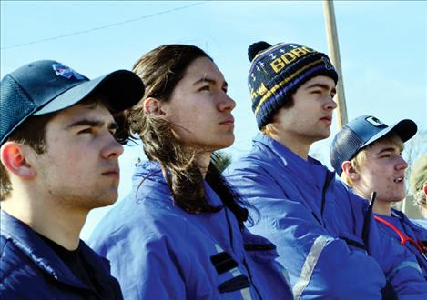 Emergency responders Israel Umphrey, Nick Durglo, Bill von Holtum and Robbie Erickson watch as a helicopter takes off from the scene of the accident.