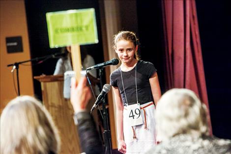 With fingers clenched, Taleah Hernandez watches the correct sign rise after accurately spelling “chihuahua” and “conglomerate” to win her second consecutive Lake County Spelling Bee.