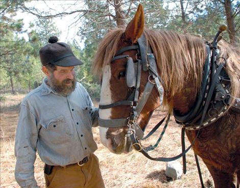 Bess logs alongside David Sturman on a forest beautification and health project.