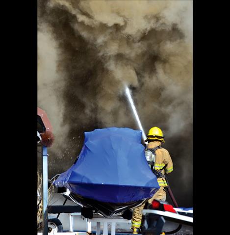 Fire crews  battle  the blaze  at S&S Sports in Ronan on Monday.