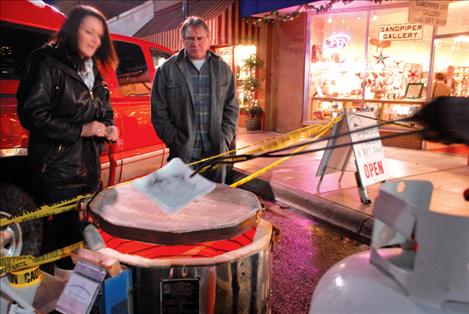 Michelle Mallon, art teacher at Ronan High School, drops strands of horsehair on a pot heated to 1,000 degrees by Polson High School art teacher Matt Holmes.