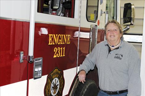 Karen Sargeant stands next to her favorite fire truck.