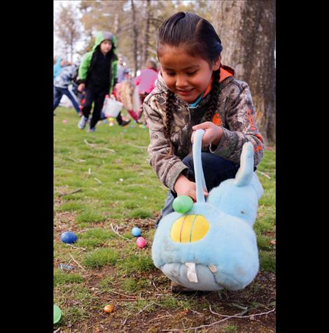 Talan Main, 5, grabs eggs at Boettcher Park in Polson. 