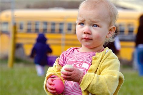 With an egg in each hand, Myah McClulley, 17 months old, is satisfied.