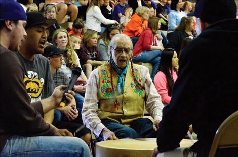 Johnny Arlee plays a drum with his group. 