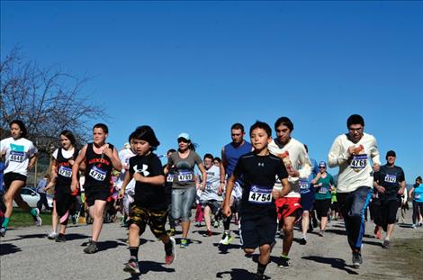 Runners take off from the starting line.