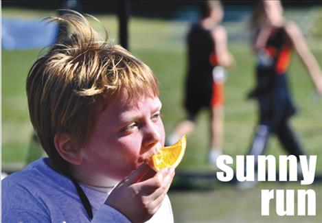 Marina Kestner-Pavlock, 8, refuels after placing fourth in the 12-and-under 1-mile Buttercup Run on Saturday in Arlee.