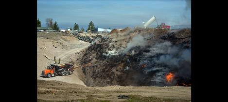 Loads of clay mixture help smother the burning rubber by Friday afternoon.