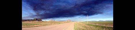 Black smoke from the Tire Depot fire spreads across the valley.