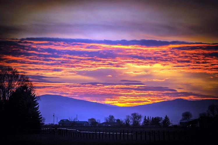 Brilliant hues of orange Illuminate the clouds at sunset