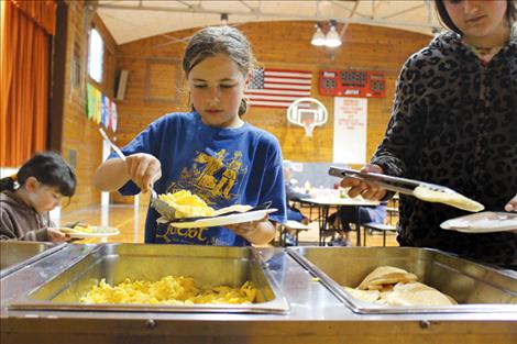 Participants load up on pancakes and eggs after the race.