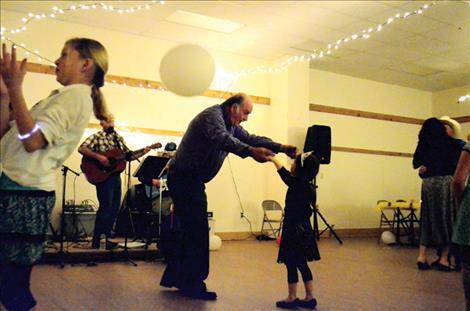 Dennis Nelson and Shy Thomas, 4, dance while the Rock Pickers play a tune .