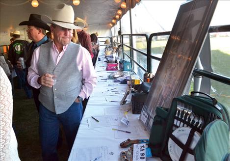 About 400 people attended the annual Cowboy Ball Friday night, bidding on auction items, feasting on a meal and dancing to country music.