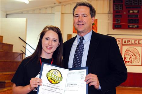 Governor Steve Bullock presents the award to Alice Corcoran, club president.