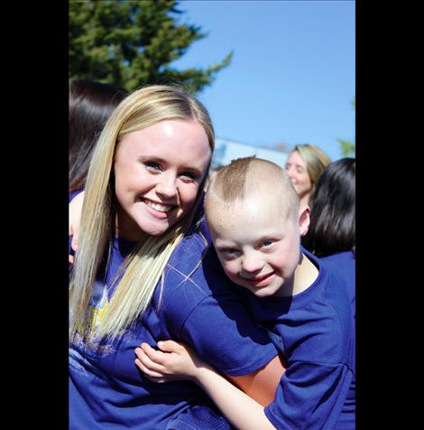 Sarah Konen, left, savors a hug from athlete Kyler Gage