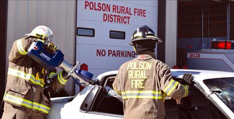A brand new Jaws of Life is demonstrated by members of the Polson Rural Fire Department. The new tool, which replaces an outdated model, was purchased through a donation the department received from Energy Keepers, Inc.