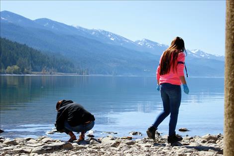 Selena Tarang searches the shoreline of Blue Bay for any presence of invasive mussels. None were found.