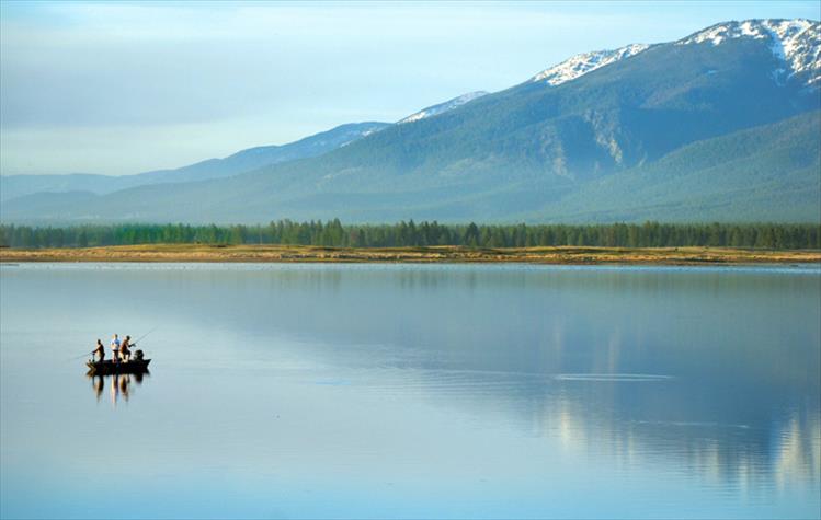 Anglers try their luck in the calm waters of Kickinghorse Reservoir Friday evening.