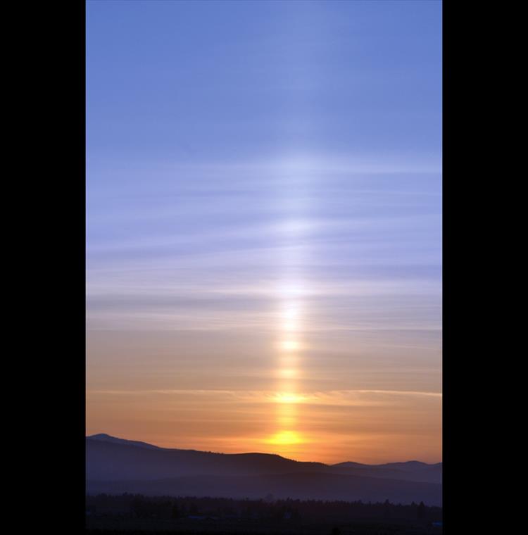 Light pillar - The setting sun's rays filter through smoke from a prescribed burn near Hot Springs