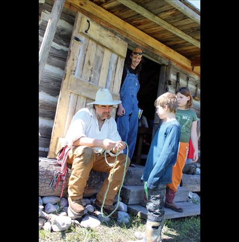  Phil Peck teaches children how to braid a rope.