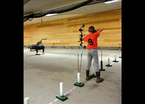 A young 4-H competitor takes aim at Lake County 4-H Shooting Sports Archery and Air Rifle event.