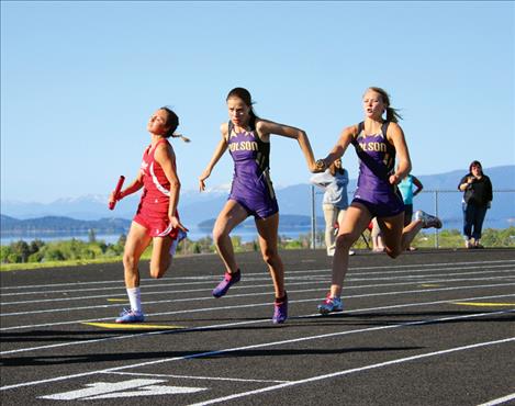 Polson Lady Pirate Mikaela Ducharme, center, grabs the baton from Chadelle Smith during the May 3 Lake County track meet held in Polson.