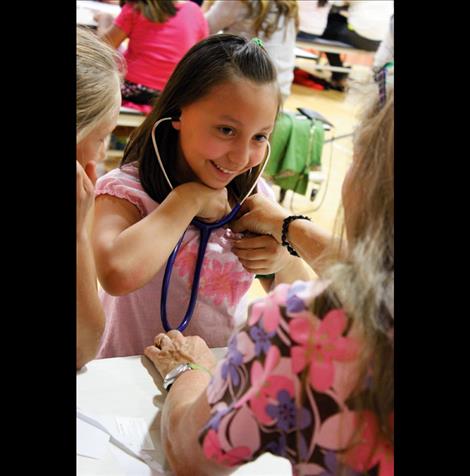 Braelyn Gano listens to her own heartbeat at Career Day.