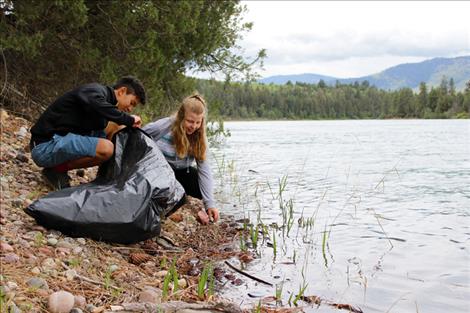 Polson Eagles Club students Perry Lambson and Kaylee Evertz help clean up the river.