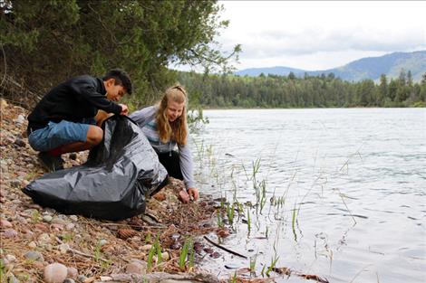 Polson Eagles Club students Perry Lambson and Kaylee Evertz help clean up the river.