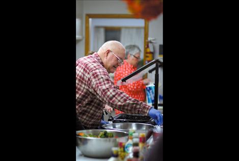 A Shepherd’s Table volunteer serves food to attendees during last week’s dinner.