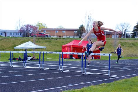 Arlee Scarlet Carlee Hergett leaps  a hurdle duing an earlier meet. Hergett placed second in both  the 100 hurdles and long jump at divisionals