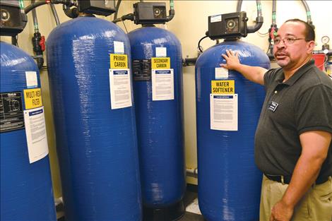 Jason Goode, area administrative assistant for Fresenius Medical Care, explains how city water is filtered and purified in the Polson facility before it is used for dialysis.