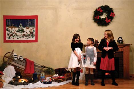 Rylie Lindquist, Kylee Niemeyer and Hannah Rowe, from left, perform “Jingle Bells” Dec. 10 at the North Crow Clubhouse Christmas party.
