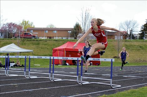 Carly Hergett runs hurdles in a meet earlier in the year.