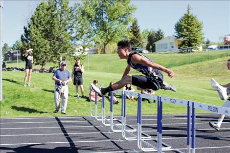 Jacob Clairmont flies over a hurdle in an earlier meet.