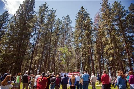 Trees stand at attention during Memorial Day services at Ronan Cemetery