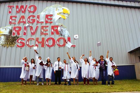 Several Two Eagle River graduates pose for a hat toss photo.