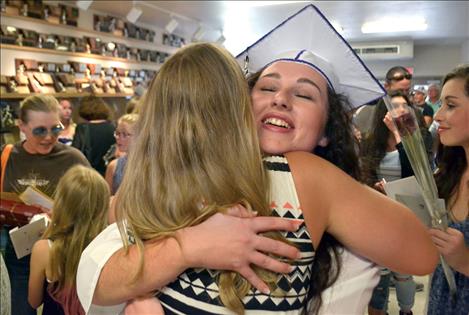 Kyla Kirsch gets a congratulatory hug following Sunday's ceremony. 