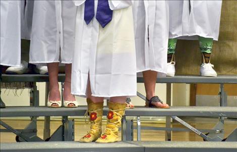 Dressed in white Vans, colorful socks and zany-printed sneakers atop his mortarboard, Dugan Runkel, upper right, says he’s headed to the Art Institute of Seattle to study industrial design. 