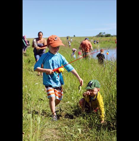 Eli Andersen, 2, takes a tumble as he heads back with his brother Milo, 4, to get their little fish weighed. It weighed 12 grams.